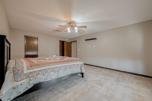 bedroom with a textured ceiling and ceiling fan