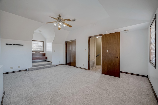 bonus room featuring lofted ceiling, light colored carpet, and ceiling fan