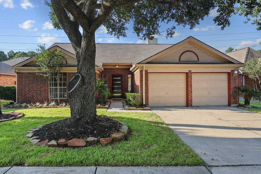 ranch-style house with a garage and a front yard