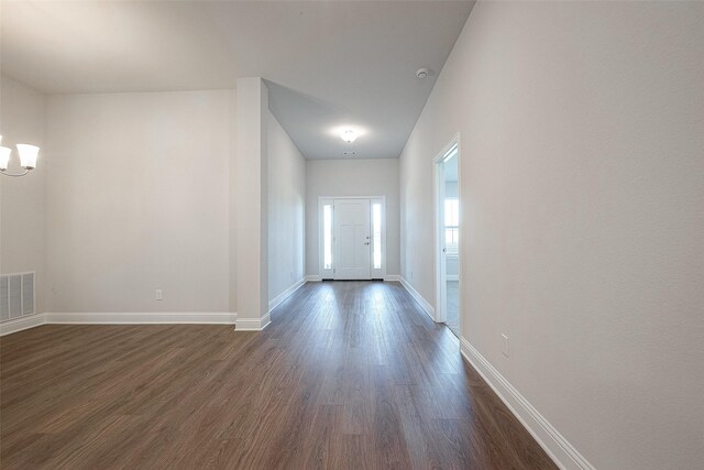 interior space featuring an inviting chandelier and dark hardwood / wood-style floors