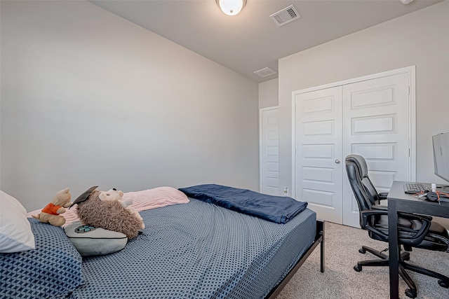 bedroom featuring lofted ceiling, light colored carpet, and a closet