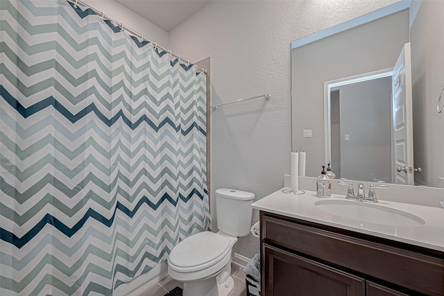 bathroom featuring vanity, toilet, and curtained shower