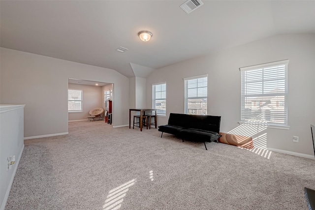 living area featuring lofted ceiling and light colored carpet