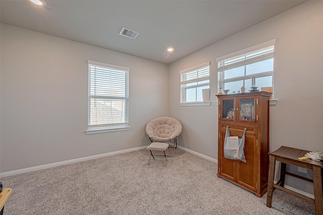 sitting room with light colored carpet and plenty of natural light