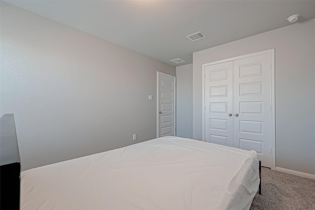 carpeted bedroom featuring a closet