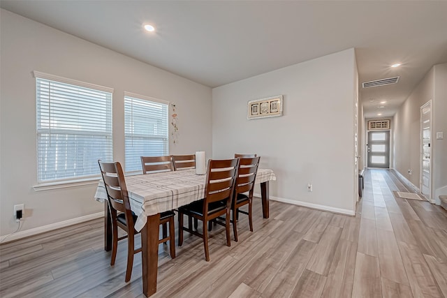 dining space featuring a wealth of natural light and light wood-type flooring