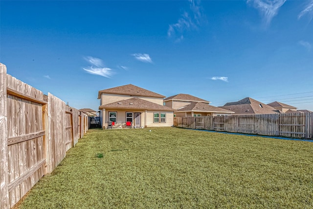 back of house with a lawn