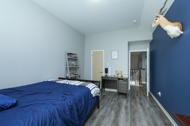 bedroom with lofted ceiling and hardwood / wood-style floors