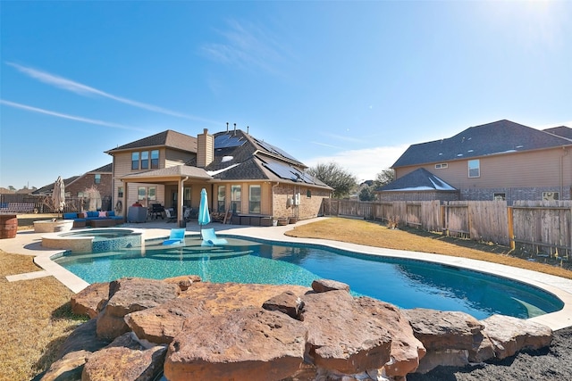 view of swimming pool with an in ground hot tub