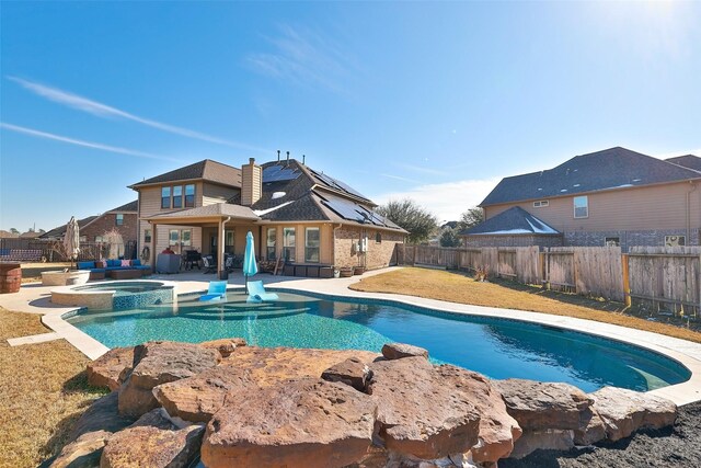 view of swimming pool with an in ground hot tub