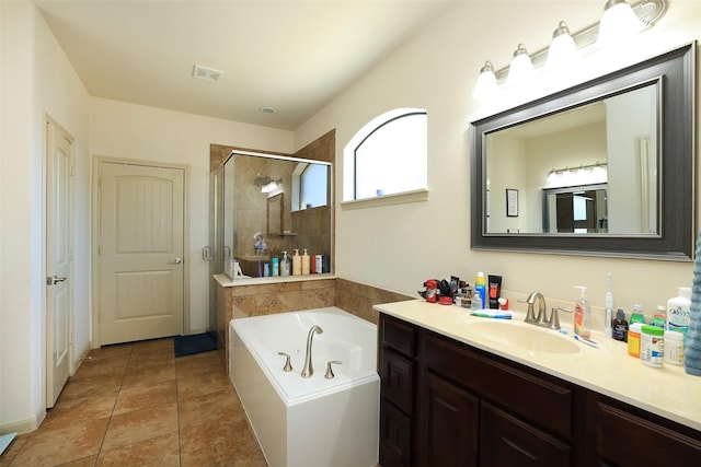 bathroom featuring tile patterned flooring, vanity, and separate shower and tub