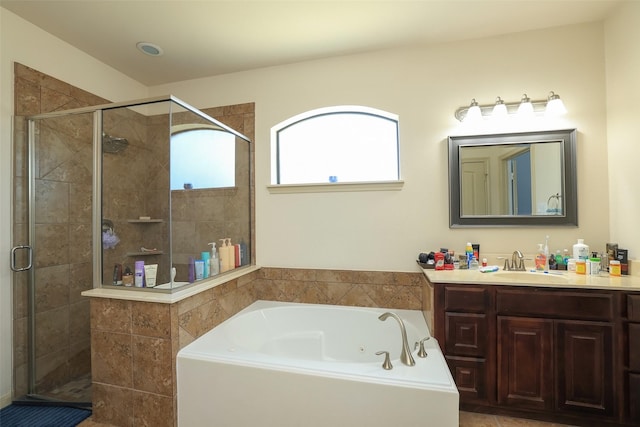 bathroom with vanity and separate shower and tub