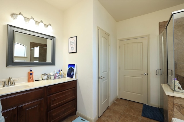 bathroom with tile patterned floors, a shower with shower door, and vanity