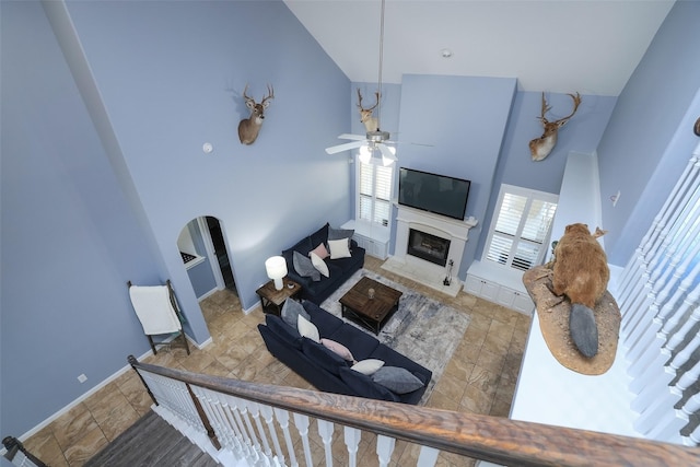 living room with high vaulted ceiling and ceiling fan