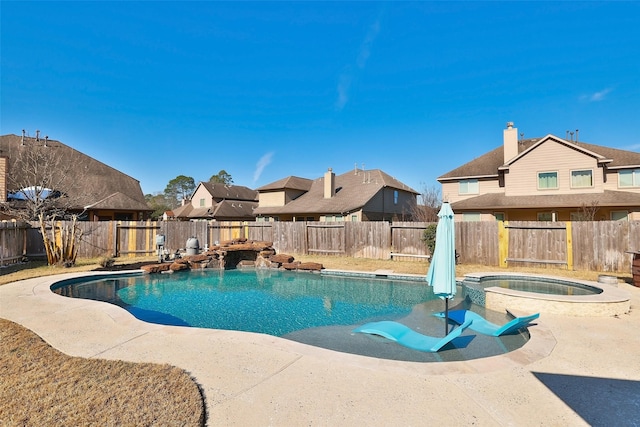 view of swimming pool featuring an in ground hot tub