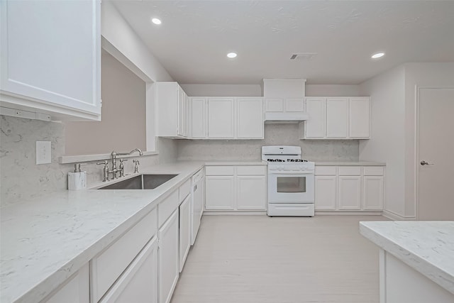 kitchen with white cabinetry, white range with gas cooktop, and sink