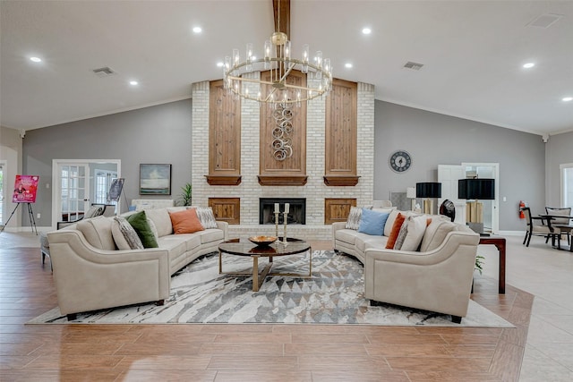 living room featuring vaulted ceiling, a fireplace, ornamental molding, a notable chandelier, and french doors