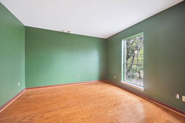 empty room featuring plenty of natural light and light wood-type flooring