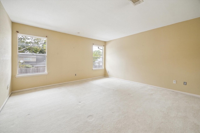 spare room with light colored carpet