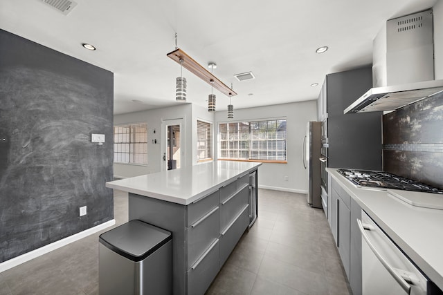 kitchen featuring island range hood, a center island, hanging light fixtures, appliances with stainless steel finishes, and gray cabinets