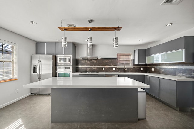 kitchen featuring a kitchen island, gray cabinets, and appliances with stainless steel finishes