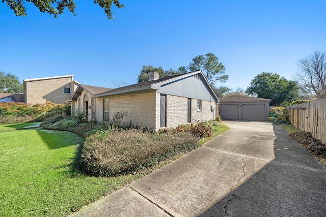 view of side of property with a garage and a lawn