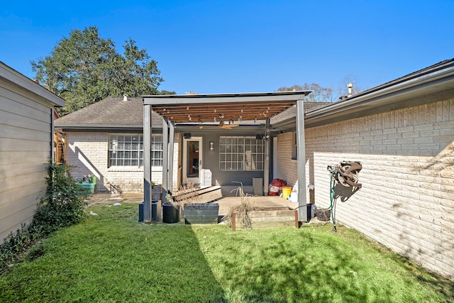 rear view of property featuring a yard