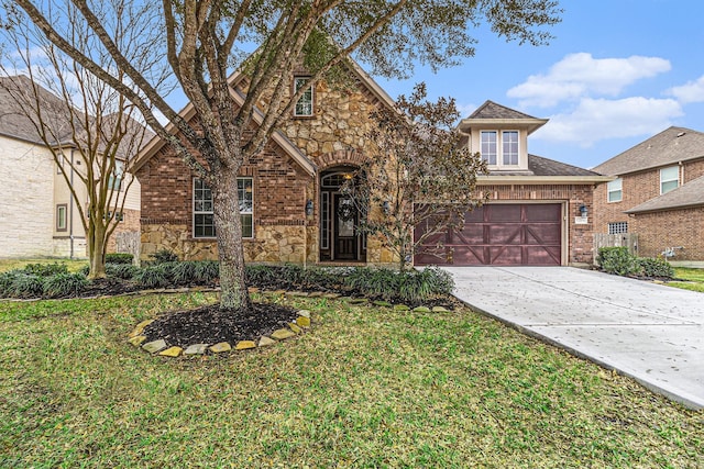 view of front facade with a garage and a front lawn