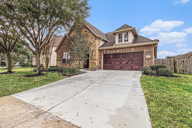 view of front of house featuring a garage and a front lawn