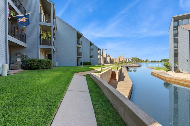 exterior space with a water view and a yard