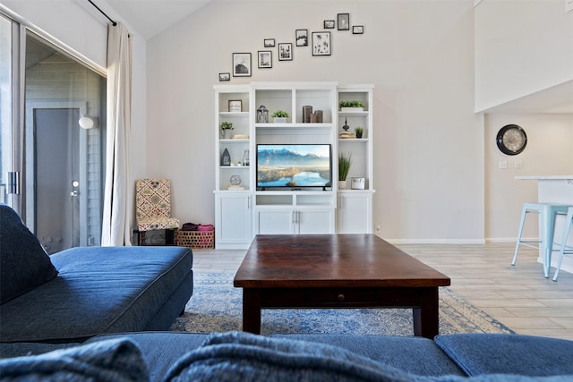 living room with lofted ceiling and light hardwood / wood-style flooring