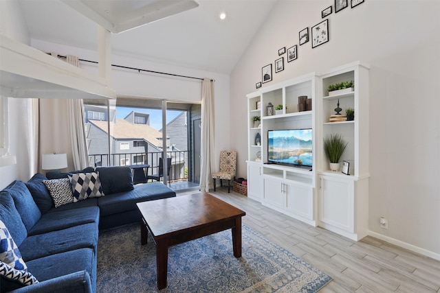 living room featuring high vaulted ceiling and light wood-type flooring