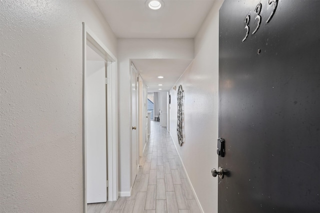 corridor with light wood-type flooring