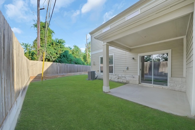 view of yard with a patio, central AC, and a fenced backyard