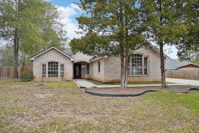 ranch-style house with a front lawn