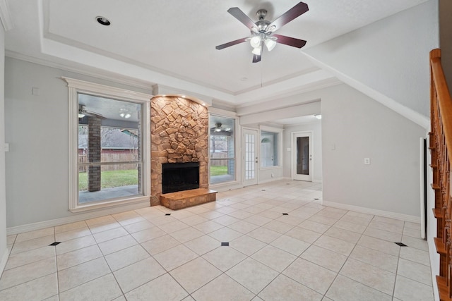 unfurnished living room featuring light tile patterned floors, a fireplace, and a raised ceiling