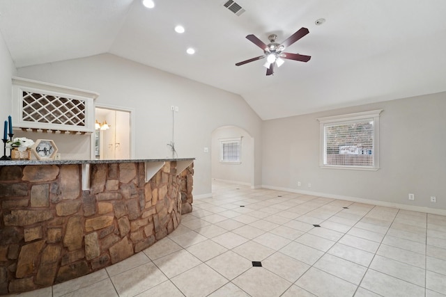 tiled living room with lofted ceiling and ceiling fan