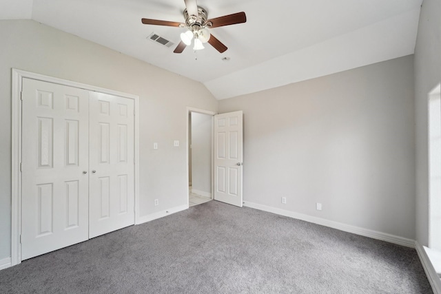 unfurnished bedroom with vaulted ceiling, carpet flooring, ceiling fan, and a closet