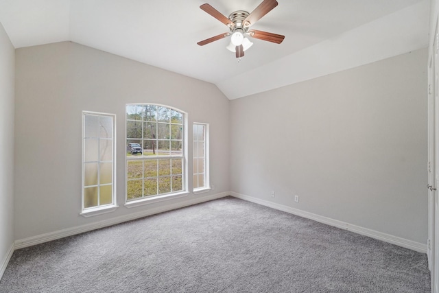 carpeted empty room with ceiling fan and lofted ceiling