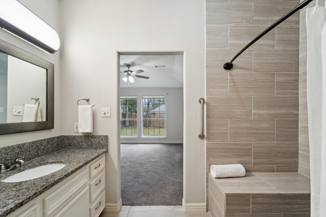 bathroom with vanity, ceiling fan, and a shower