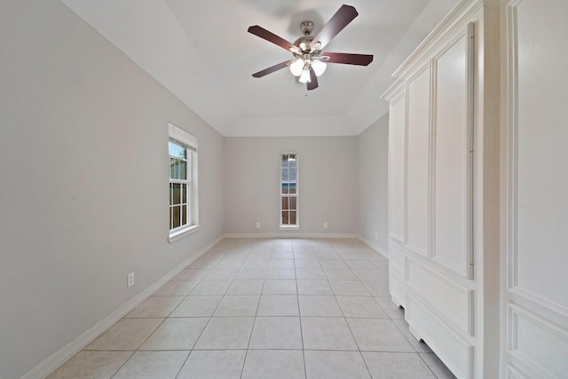 tiled empty room featuring ceiling fan