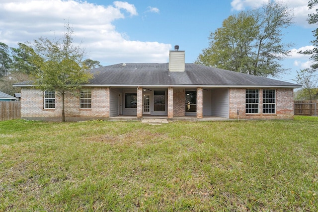 back of house featuring a yard and a patio area