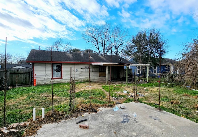 rear view of property featuring a yard