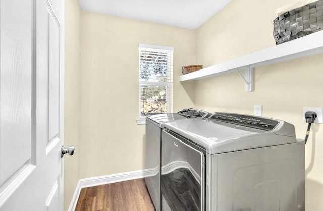 clothes washing area featuring independent washer and dryer and hardwood / wood-style floors