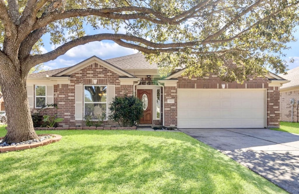 single story home with a garage and a front yard