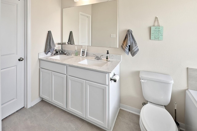 bathroom featuring tile patterned flooring, vanity, and toilet