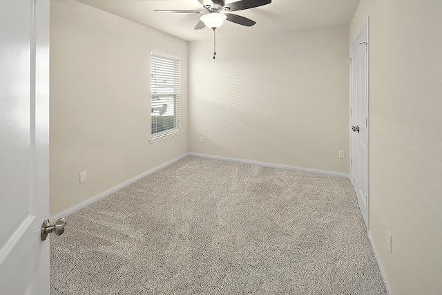 unfurnished room featuring light colored carpet and ceiling fan