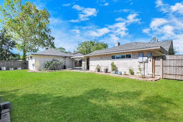 rear view of house with a yard