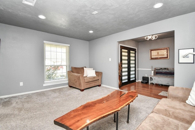 living room featuring carpet floors and a textured ceiling