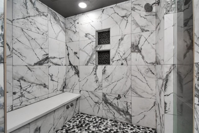 bathroom with a tile shower